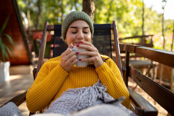 woman enjoying hot drink in fall